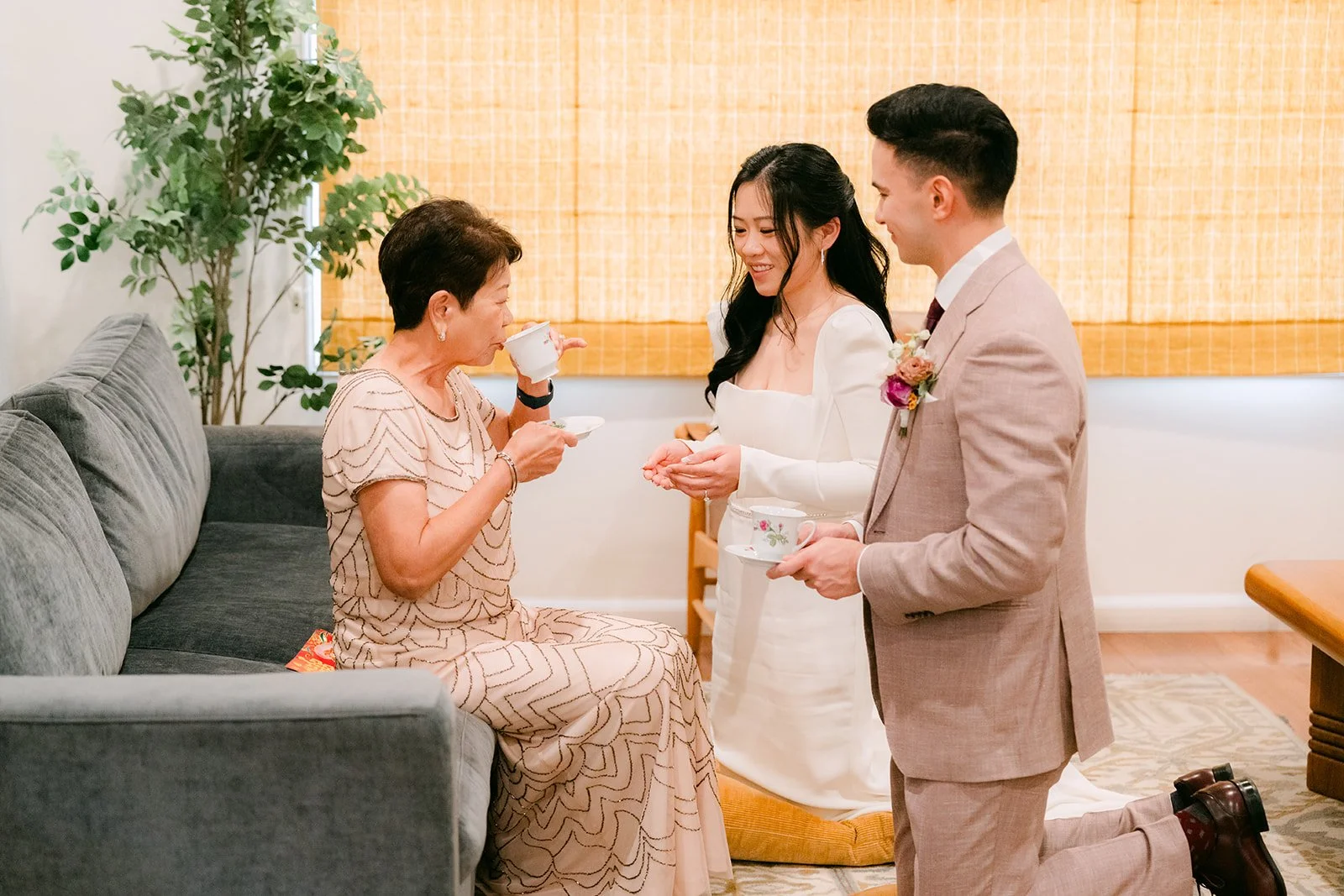 Denise's mom sipping tea as Denise and Michael look on.