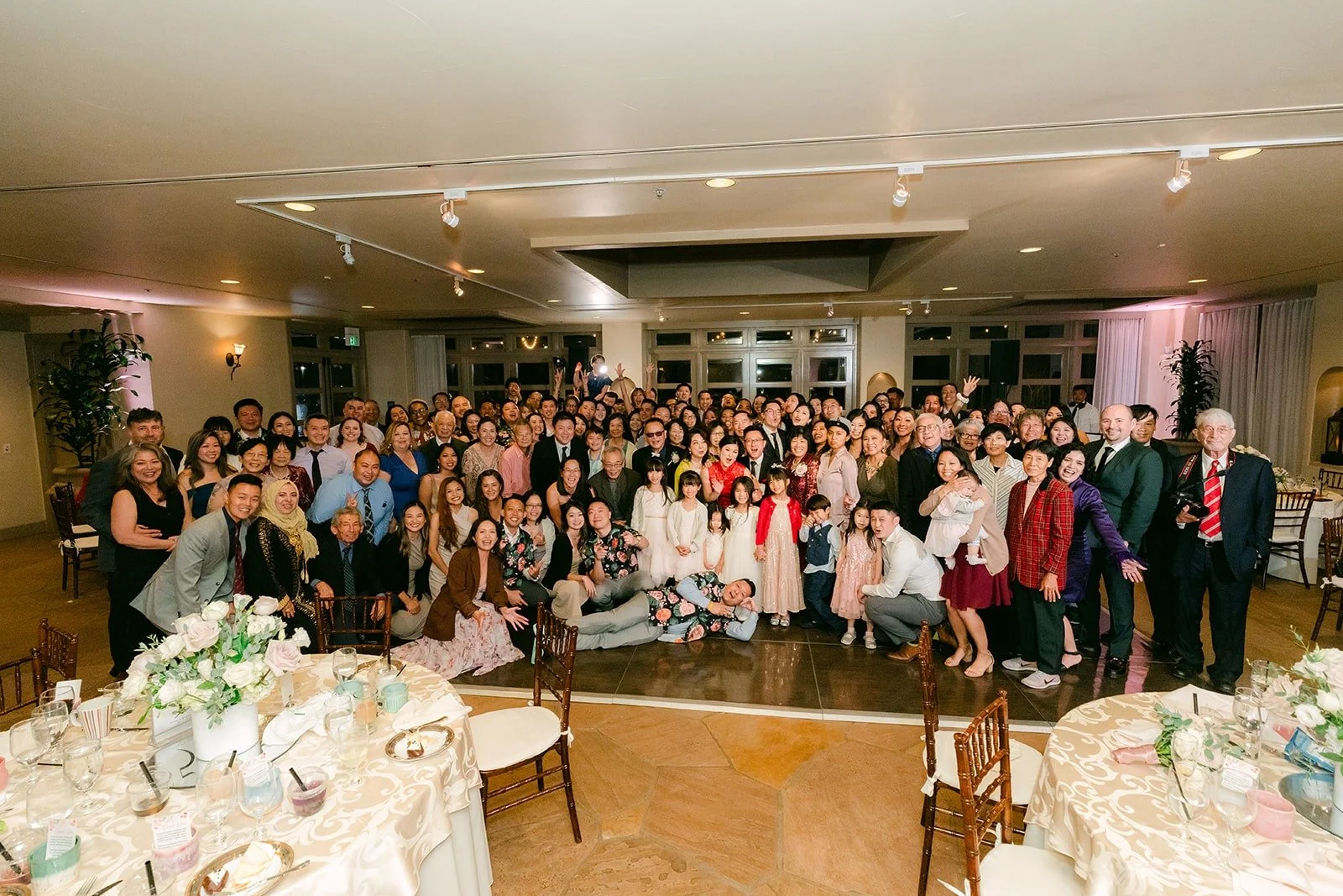 A group photo of guests filling the ballroom