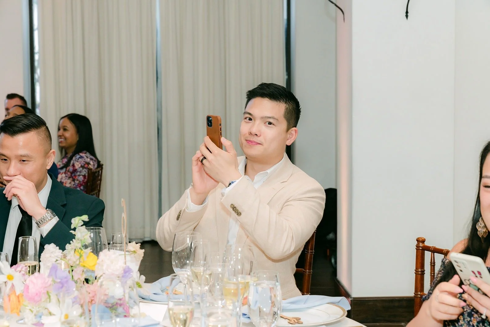 Guests cheering and filming the grand entrance from their tables