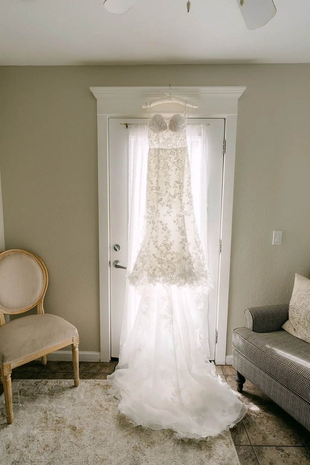 Vannie's gown hanging in a sunny doorway at The Grove of Redlands.