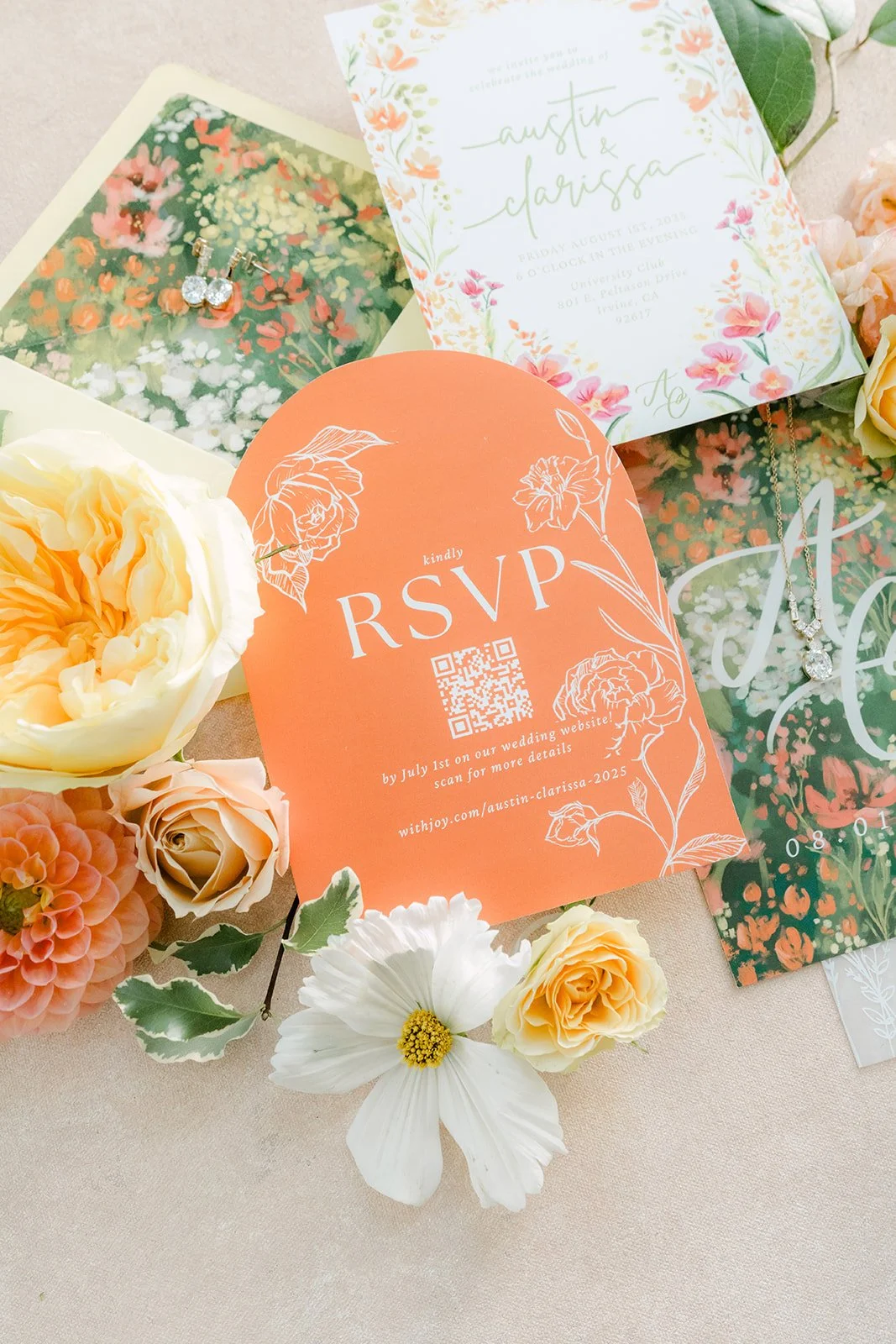 RSVP card and invitation beside yellow garden roses