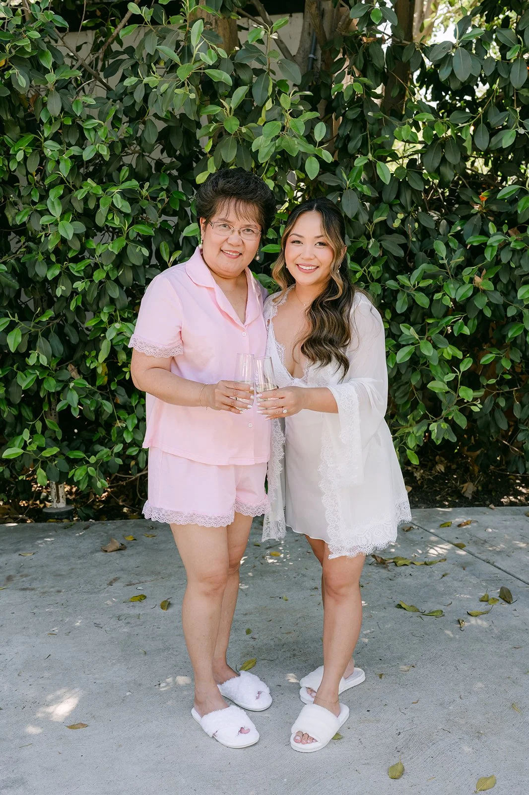 Nicole laughing with a loved one in matching pink pajamas before getting dressed.