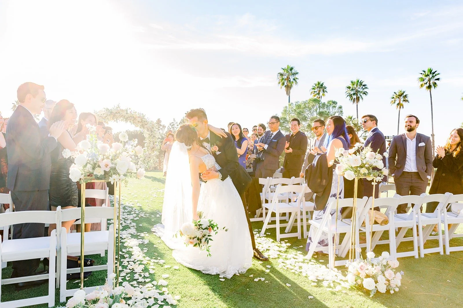 Josephine and David kissing as guests cheer