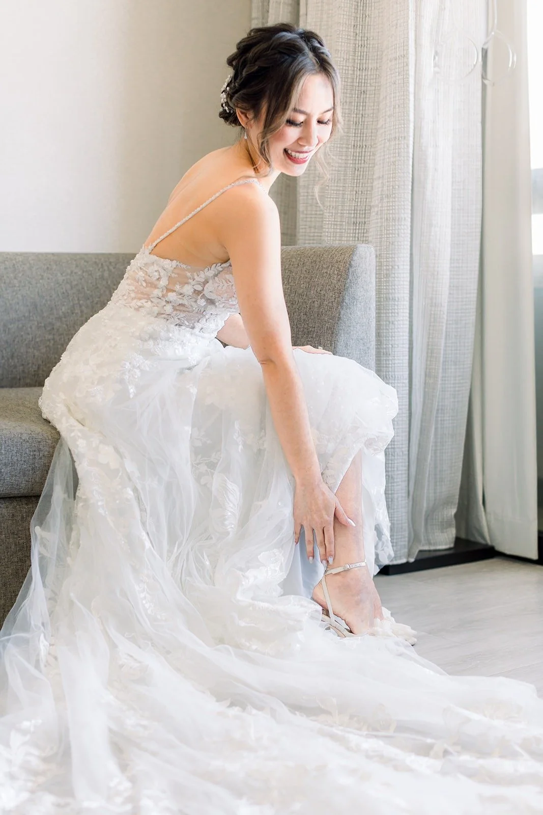 Josephine fastening her heels in her lace gown