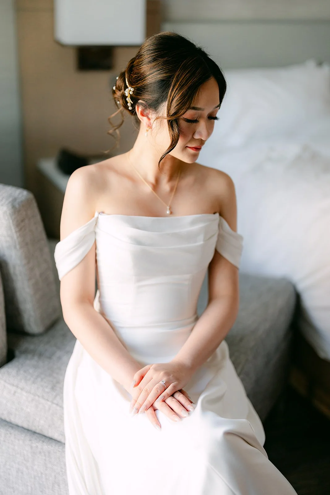 Amanda smiling softly in her off-the-shoulder gown.