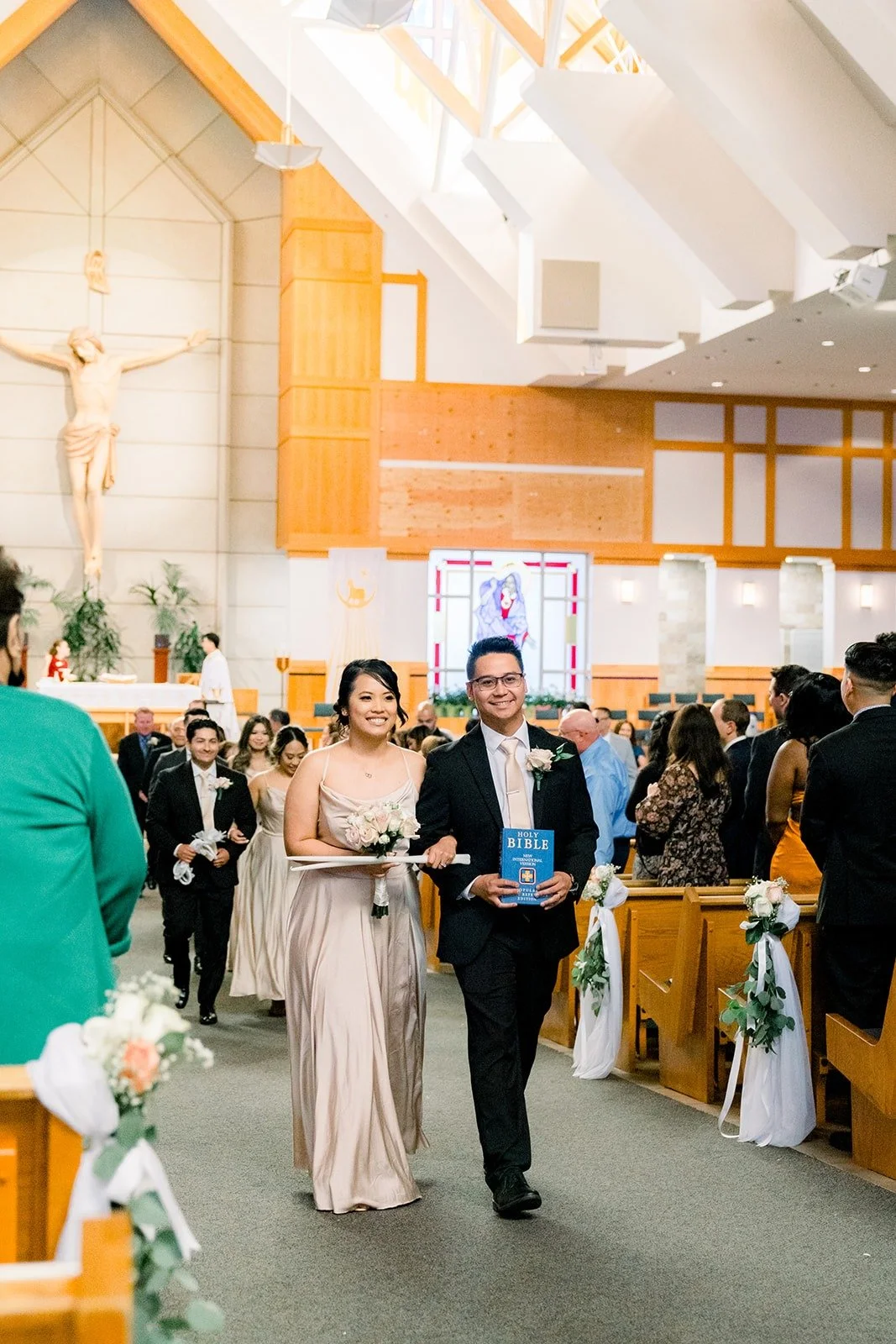 Francesca and Ralph walking back up the aisle as newlyweds