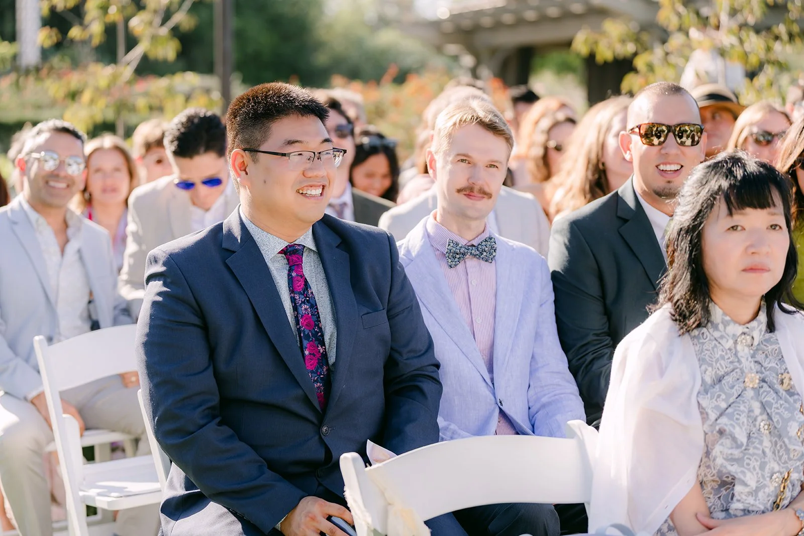 Guests smiling from their seats before the ceremony