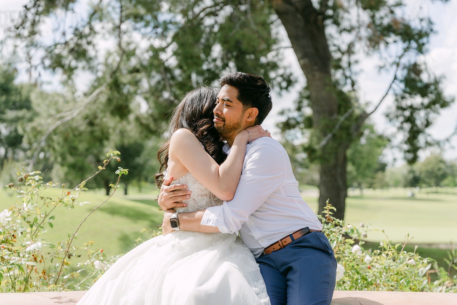 Mark kissing Natalie's cheek with the Rio Hondo golf course behind them