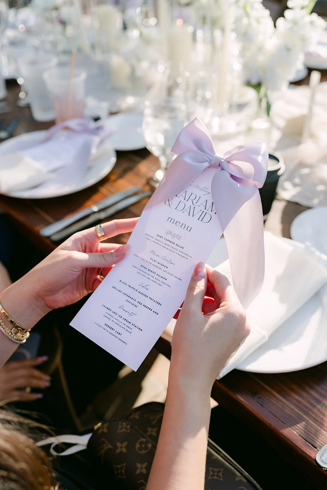 Guest holding a menu with a lavender bow