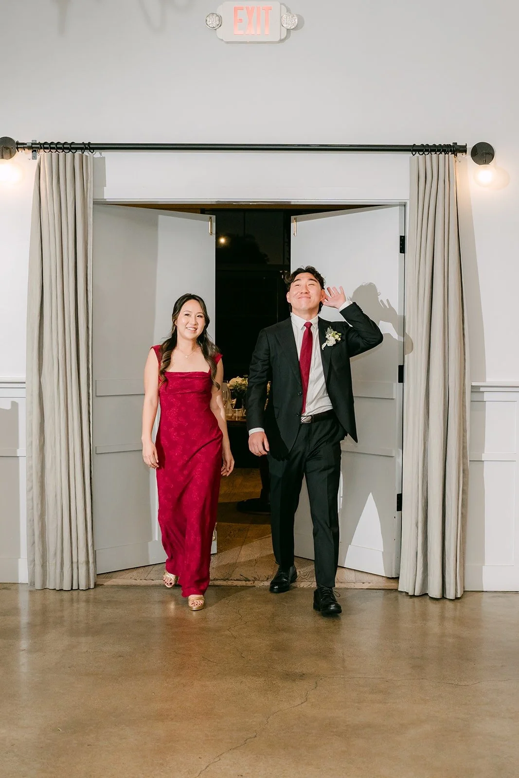 A bridesmaid and groomsman making their entrance into the reception