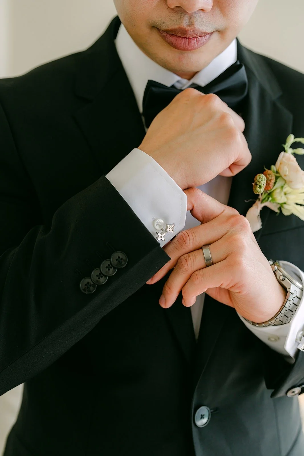 Close view of Mario fastening his cufflinks