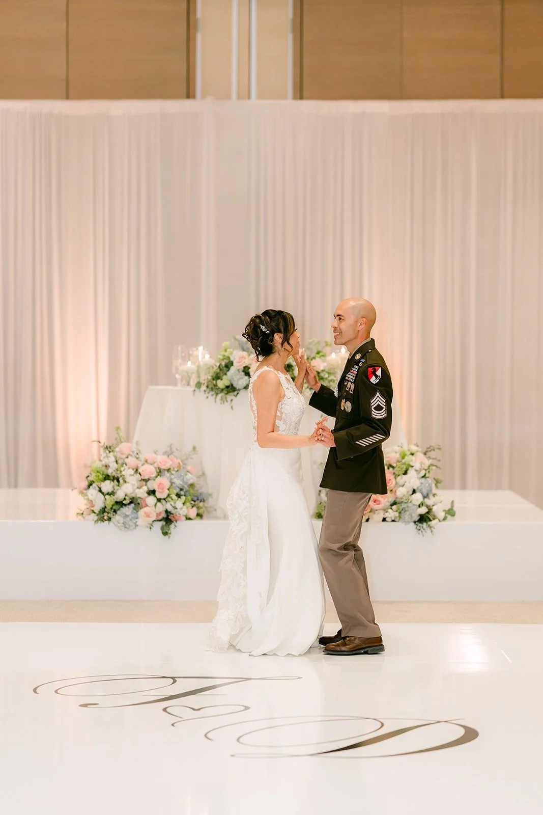 Francesca and Daniel dance in front of the sweetheart table in the Carousel Ballroom