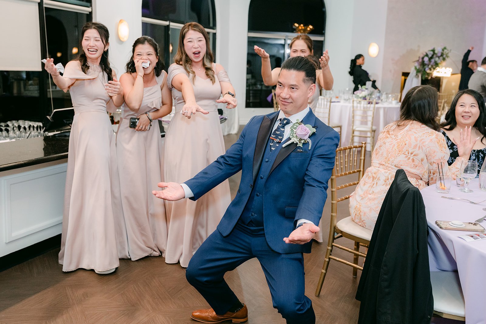The groomsmen dancing on a packed dance floor.