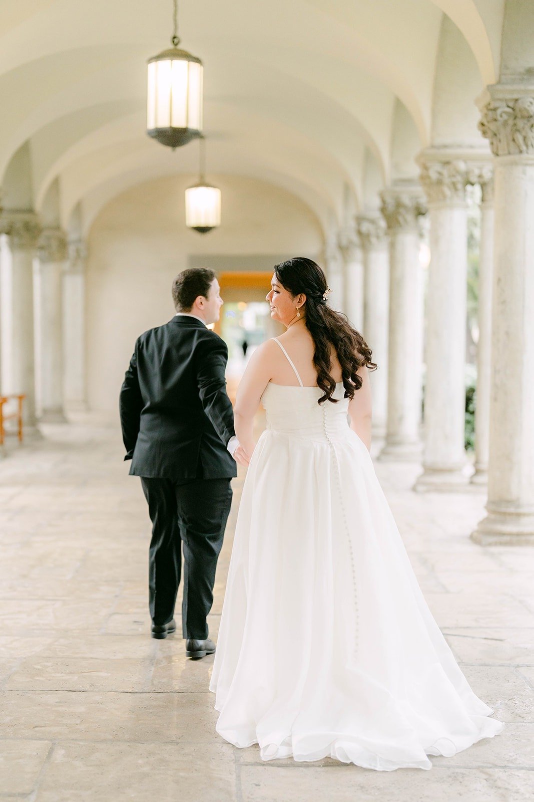 Saira and Matthew walking hand in hand down the arcade