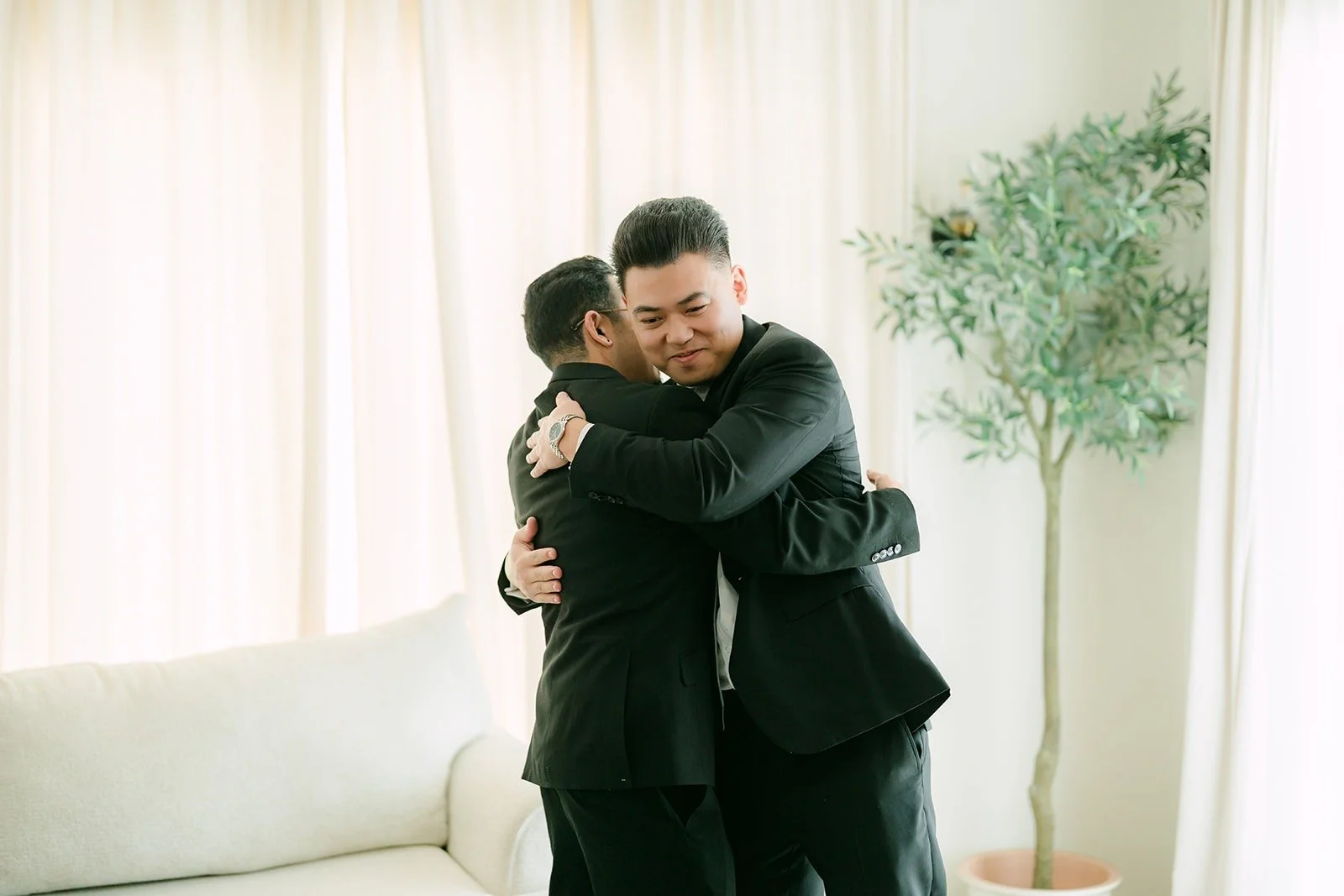 Vincent hugging a groomsman before getting dressed