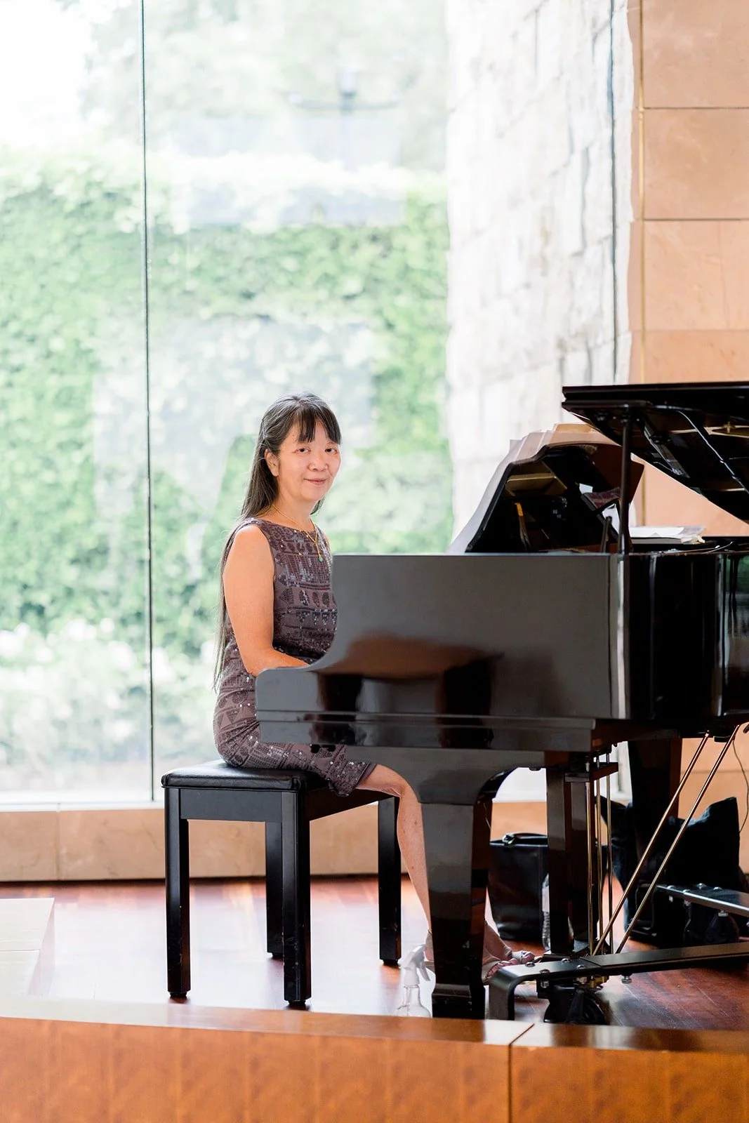 A pianist plays the grand piano before the ceremony