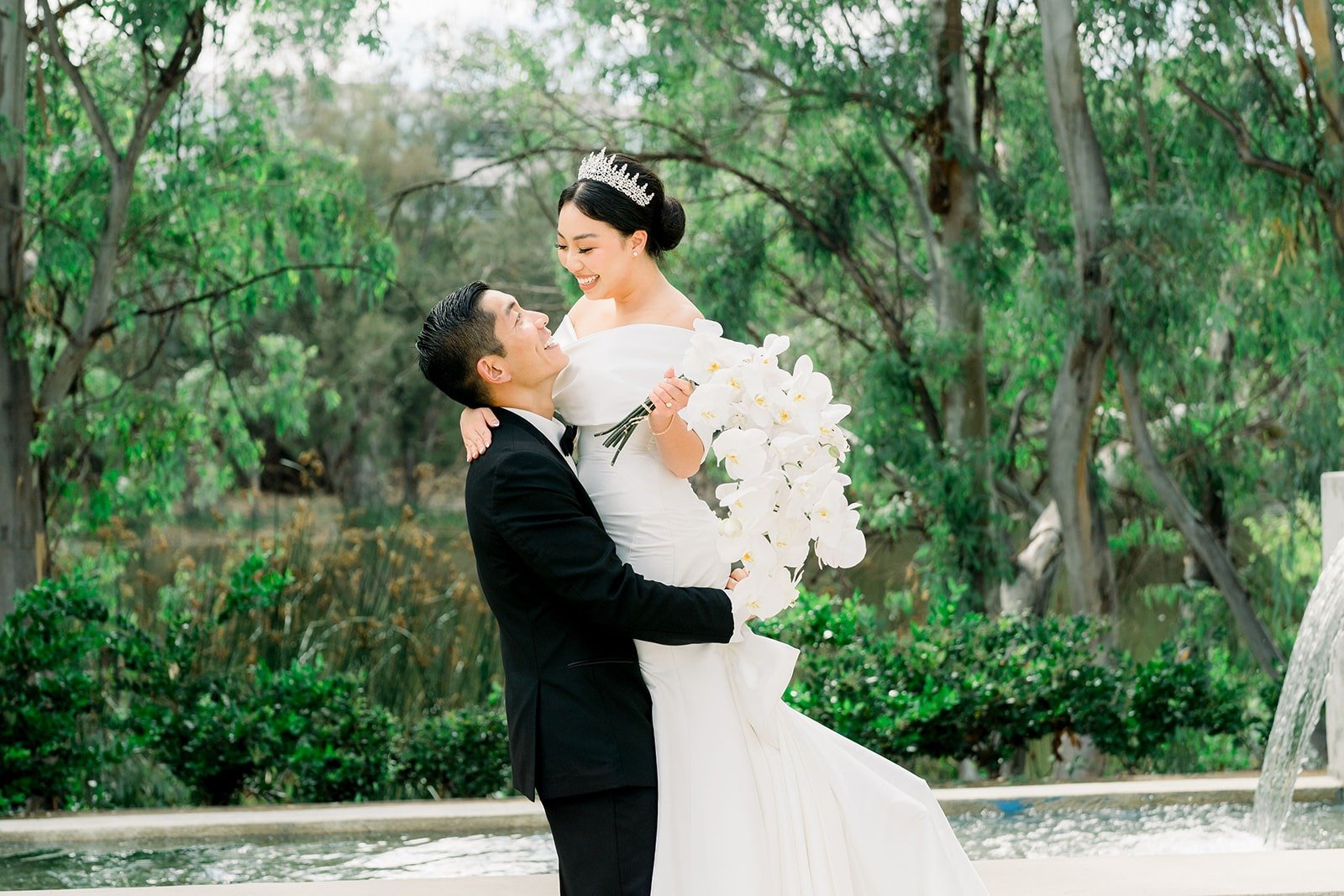 Steven dips Jacinda by the fountain