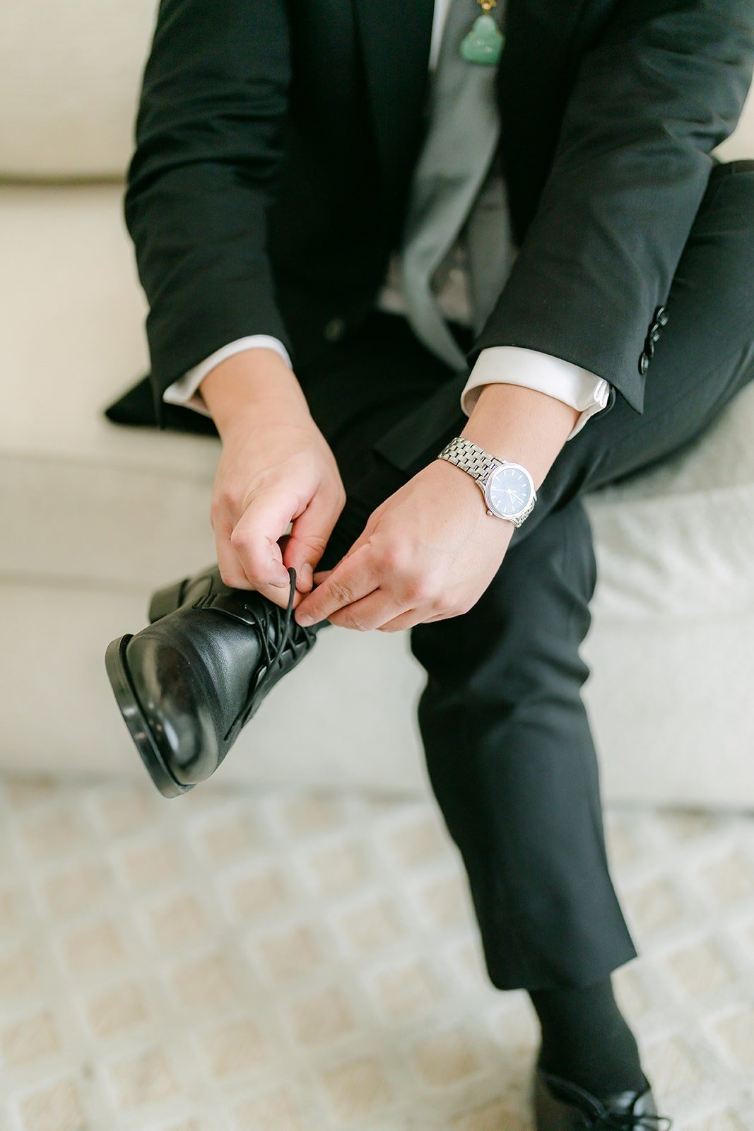 Vincent buttoning his cuff