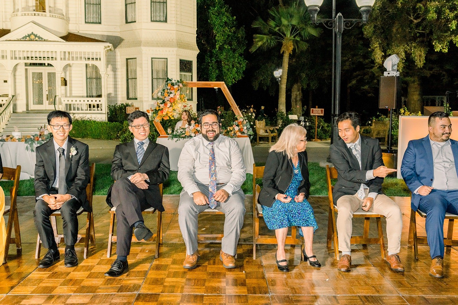 Guests lined up on chairs for a reception game