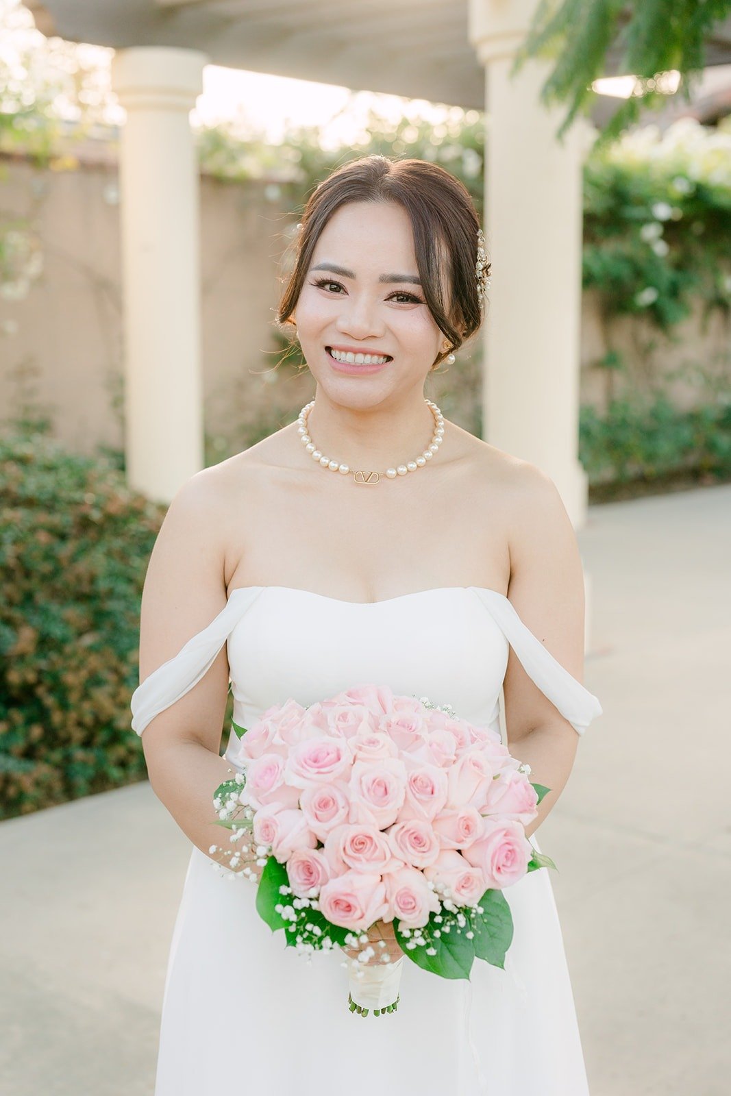 Ivy smiling with her pink rose bouquet