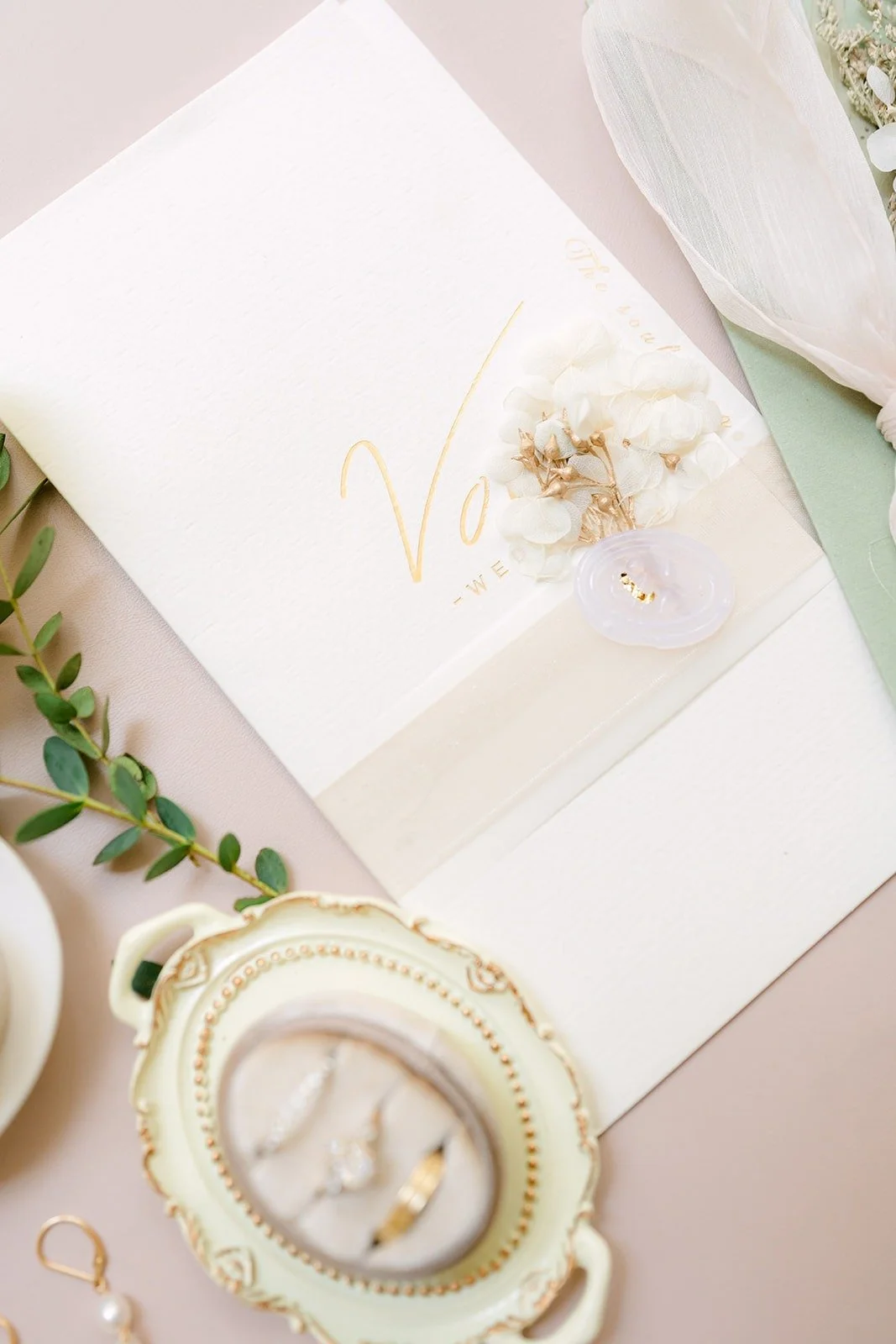 Tin's earrings and the ring box styled with greenery