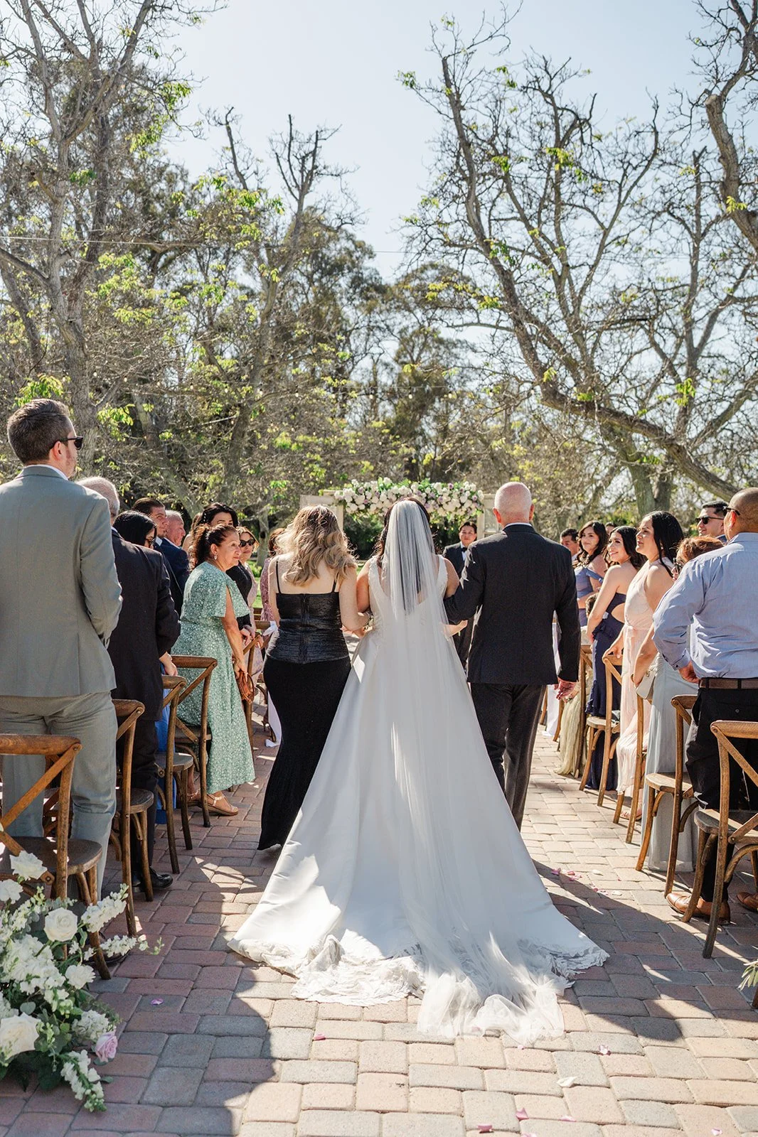 Bride walking down the aisle as guests stand