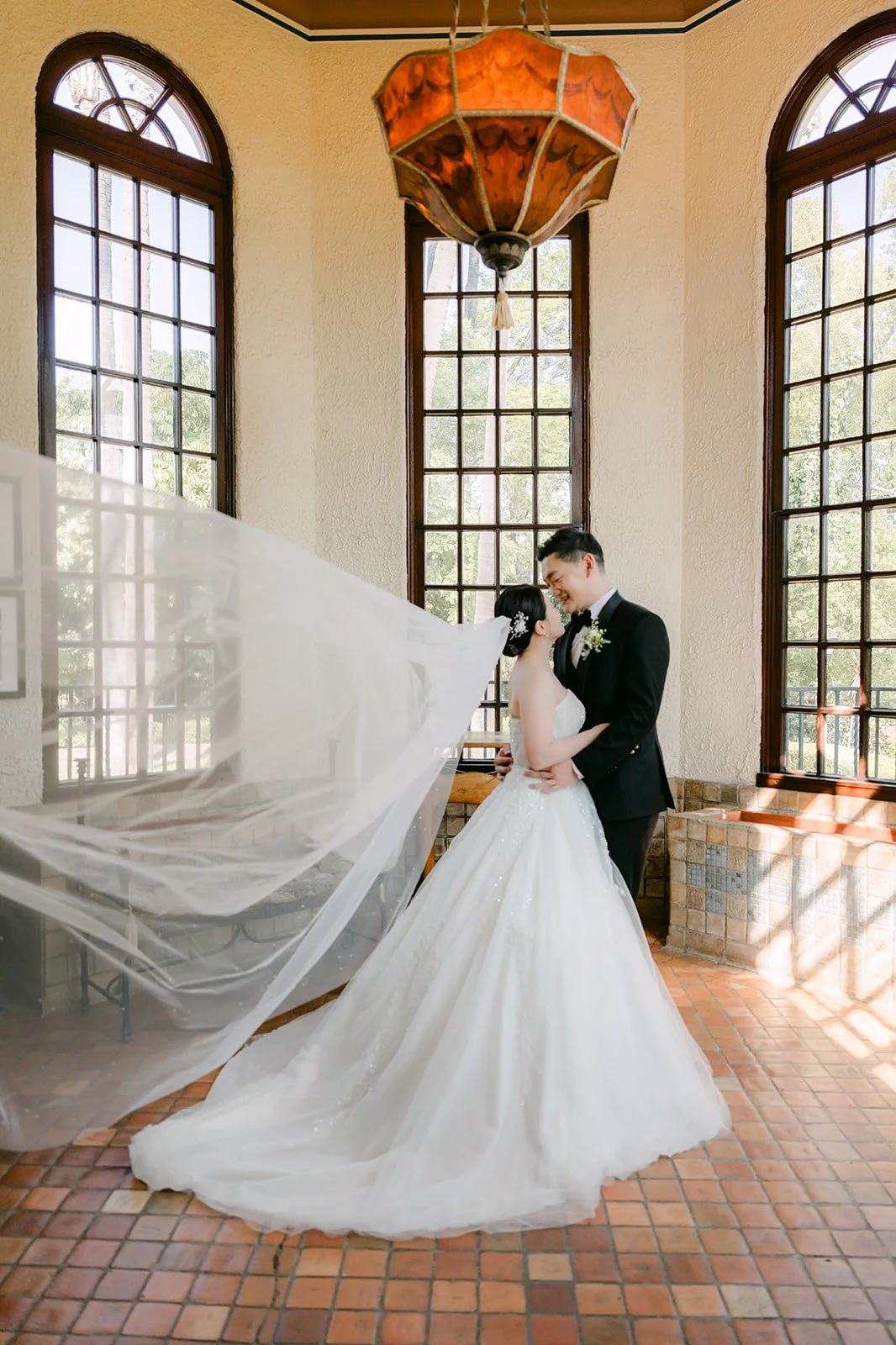 Amy's veil floating in the sunroom as Sam holds her