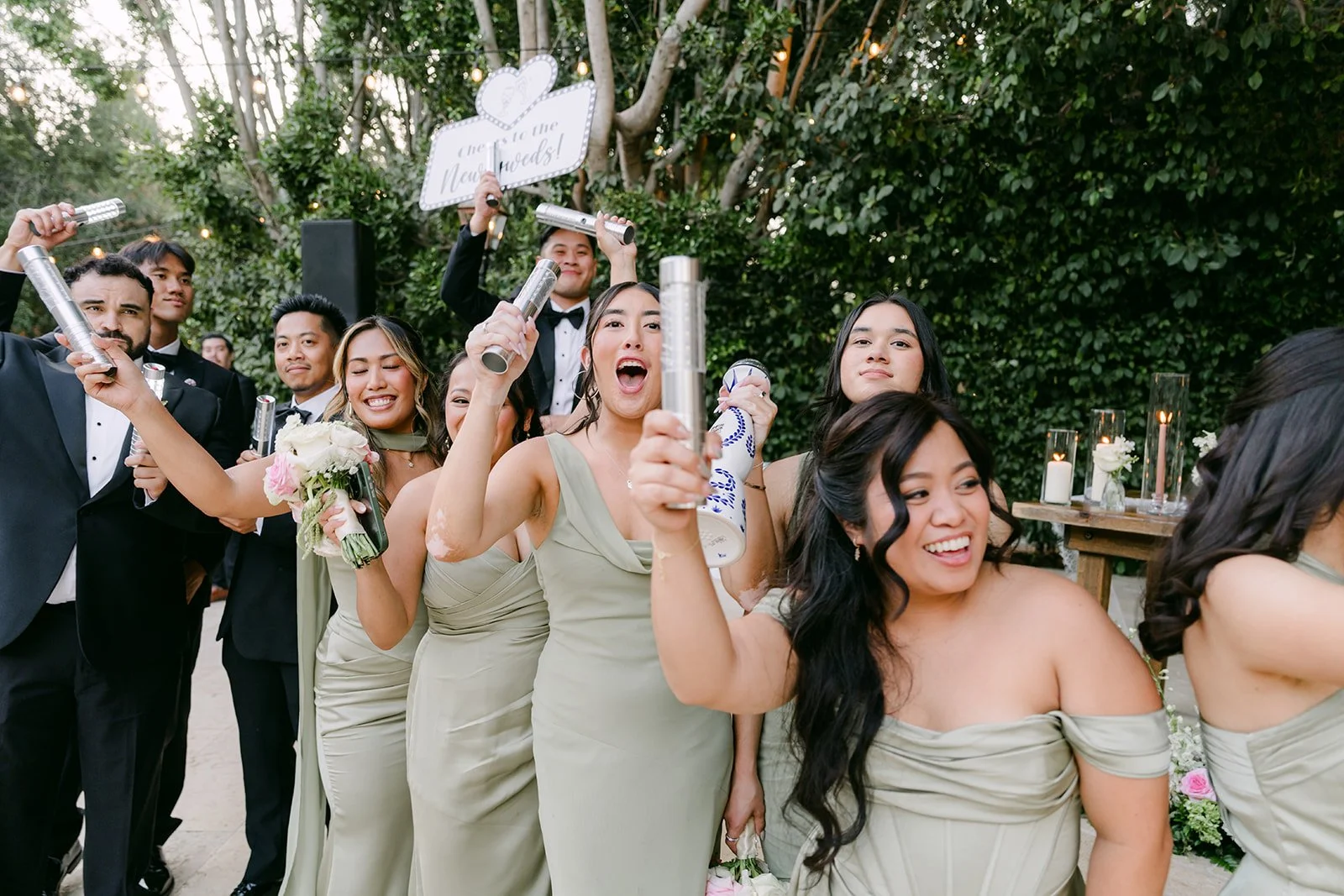 Bridesmaids in pistachio green cheering during the grand entrance at Eden Gardens.