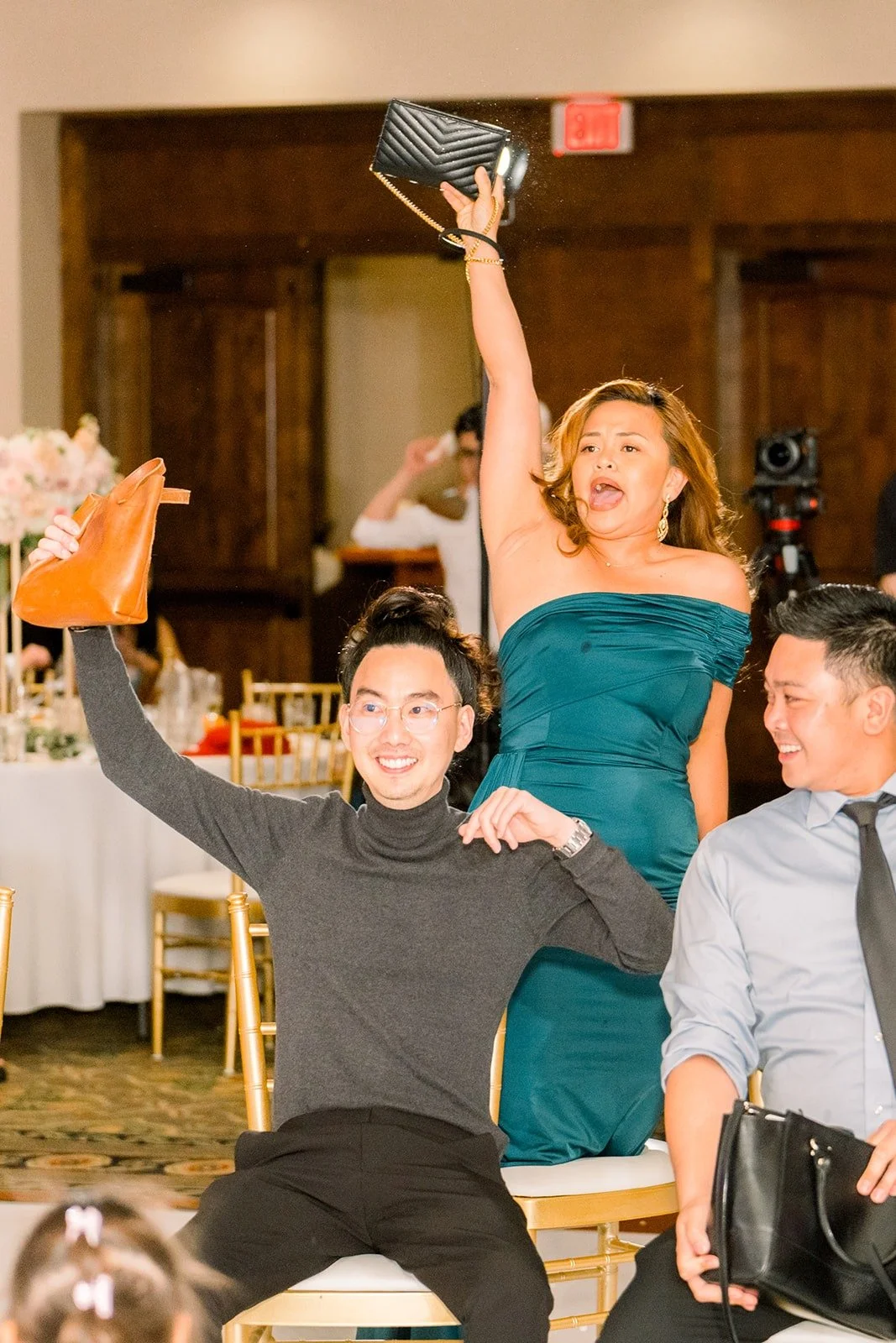 A guest cheering in her seat during a reception game