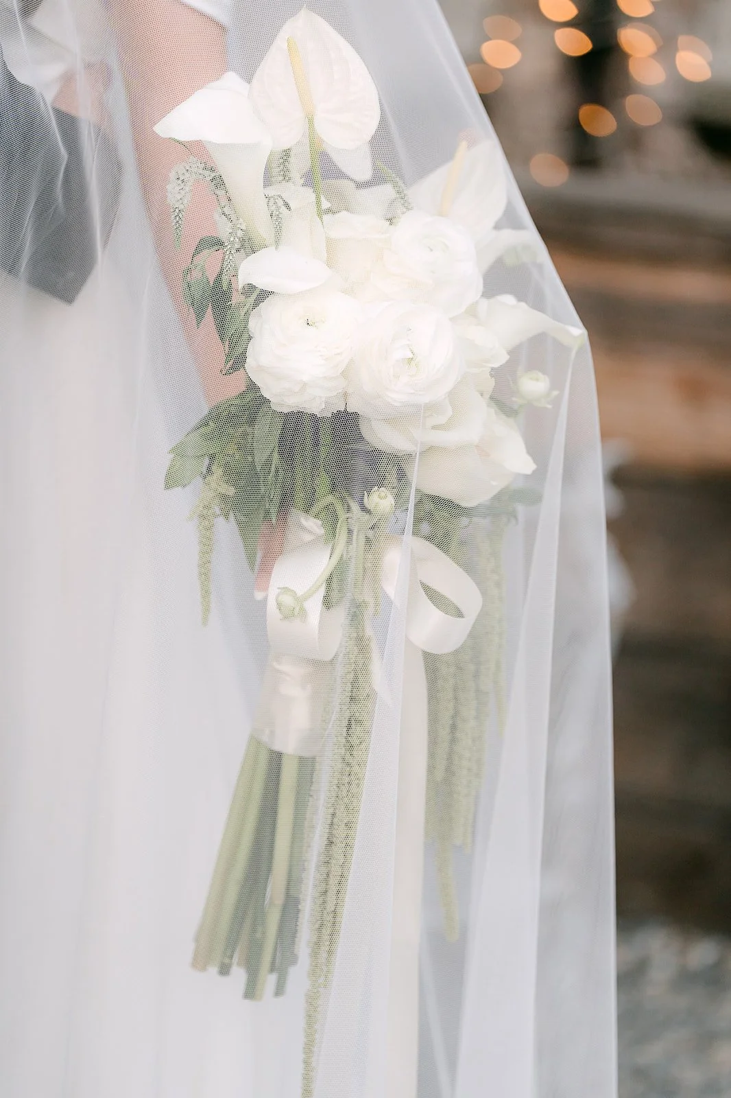 Calla lily and rose bouquet against the veil