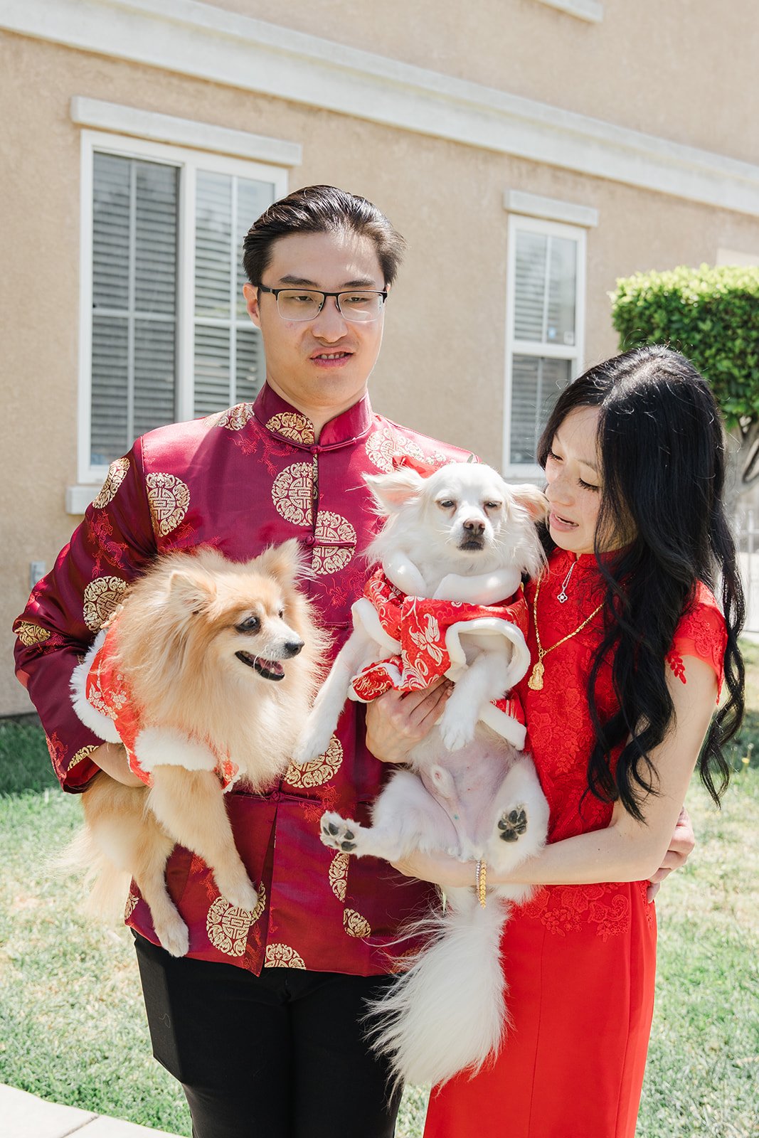 Danny holding both dogs beside Valerie.