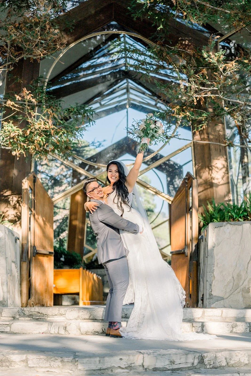 Betsy and Mikey laugh together beneath the trees, photographed by One and Only Production