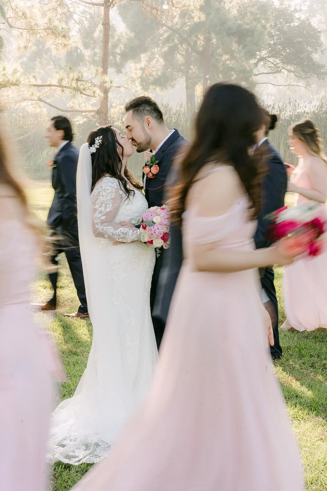 Bridesmaids and groomsmen paired up among the trees