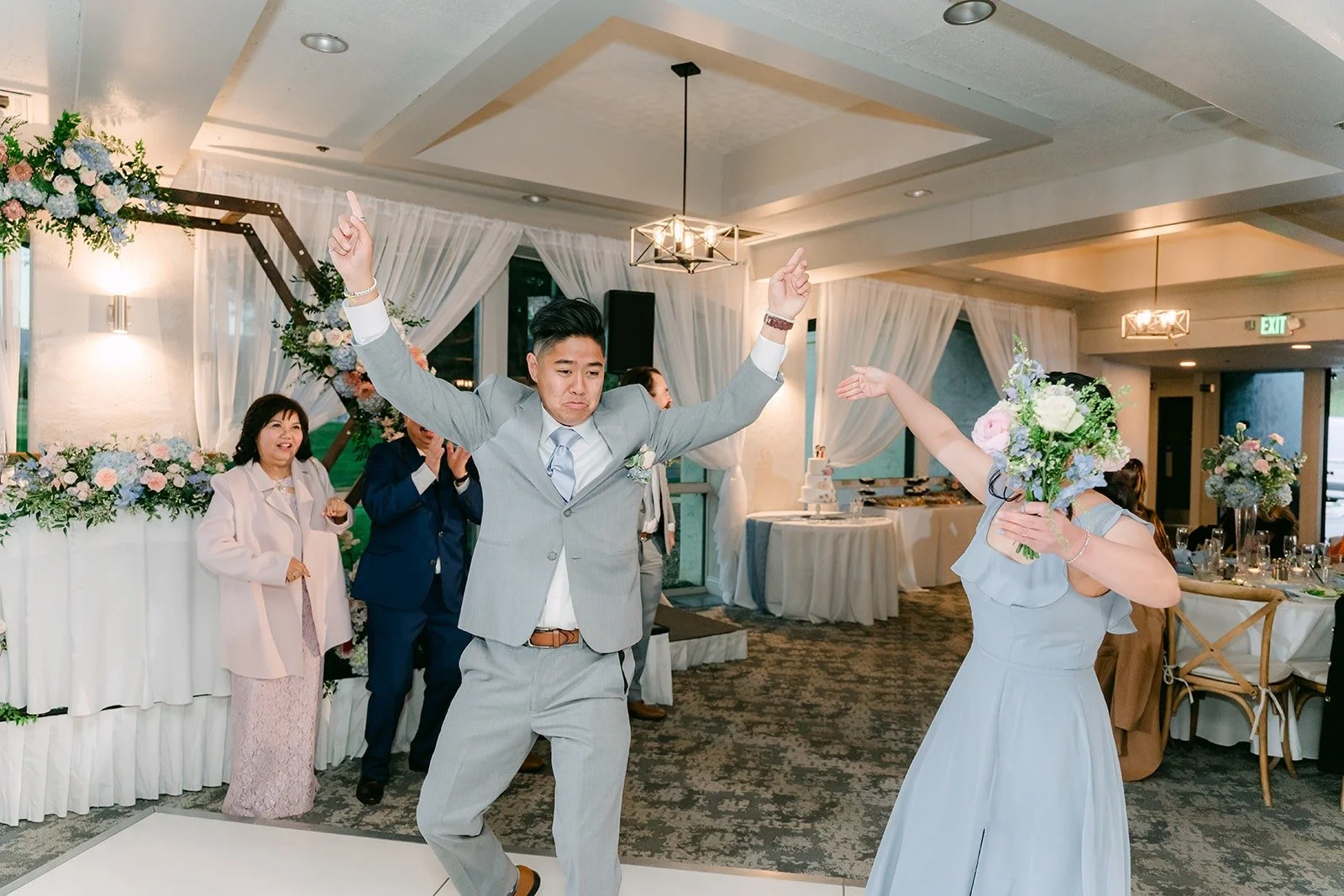 A groomsman dancing into the reception