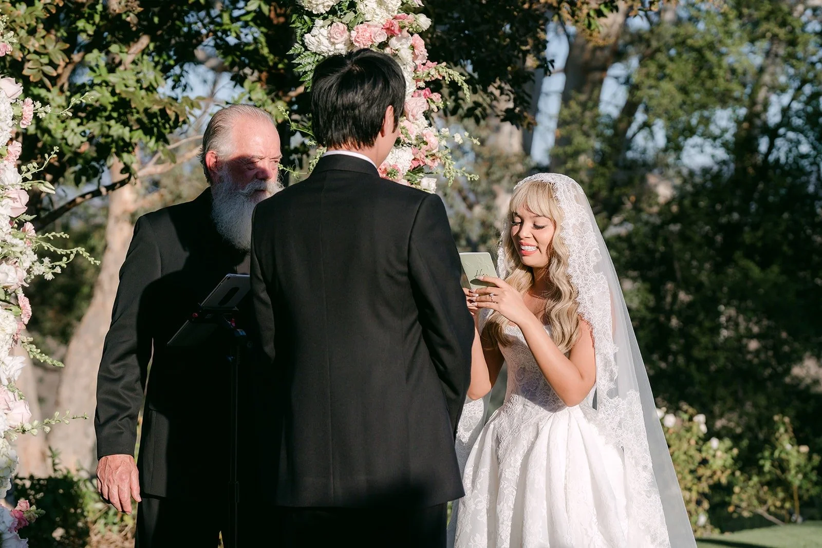 Konitha and Job facing each other as the officiant speaks