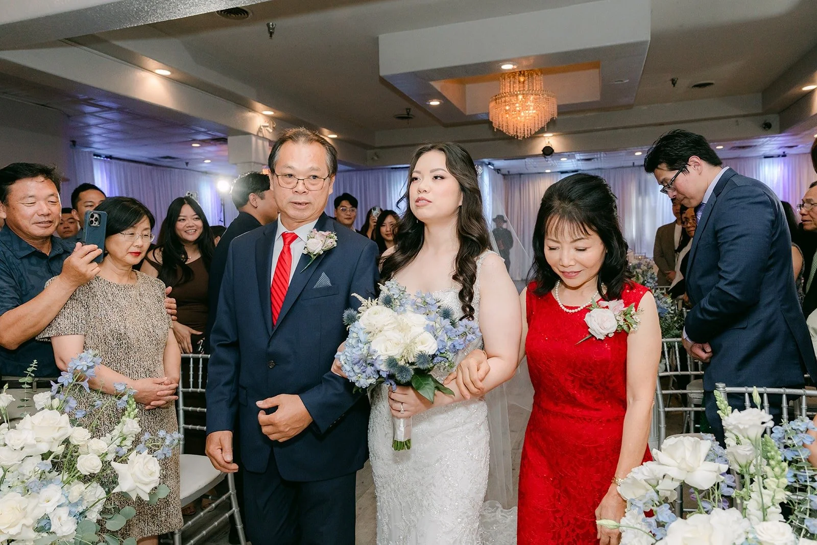 Emily walking down the aisle with family