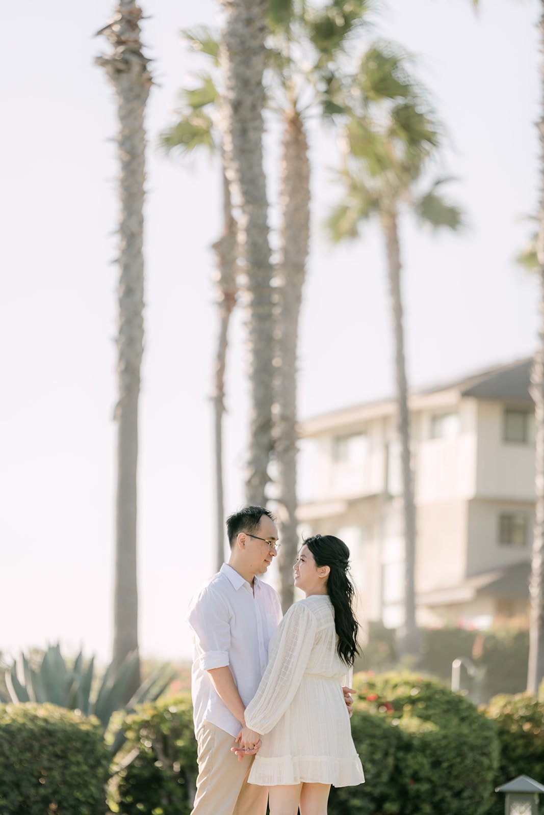 Constance and Lawrence on the lawn under tall palms.