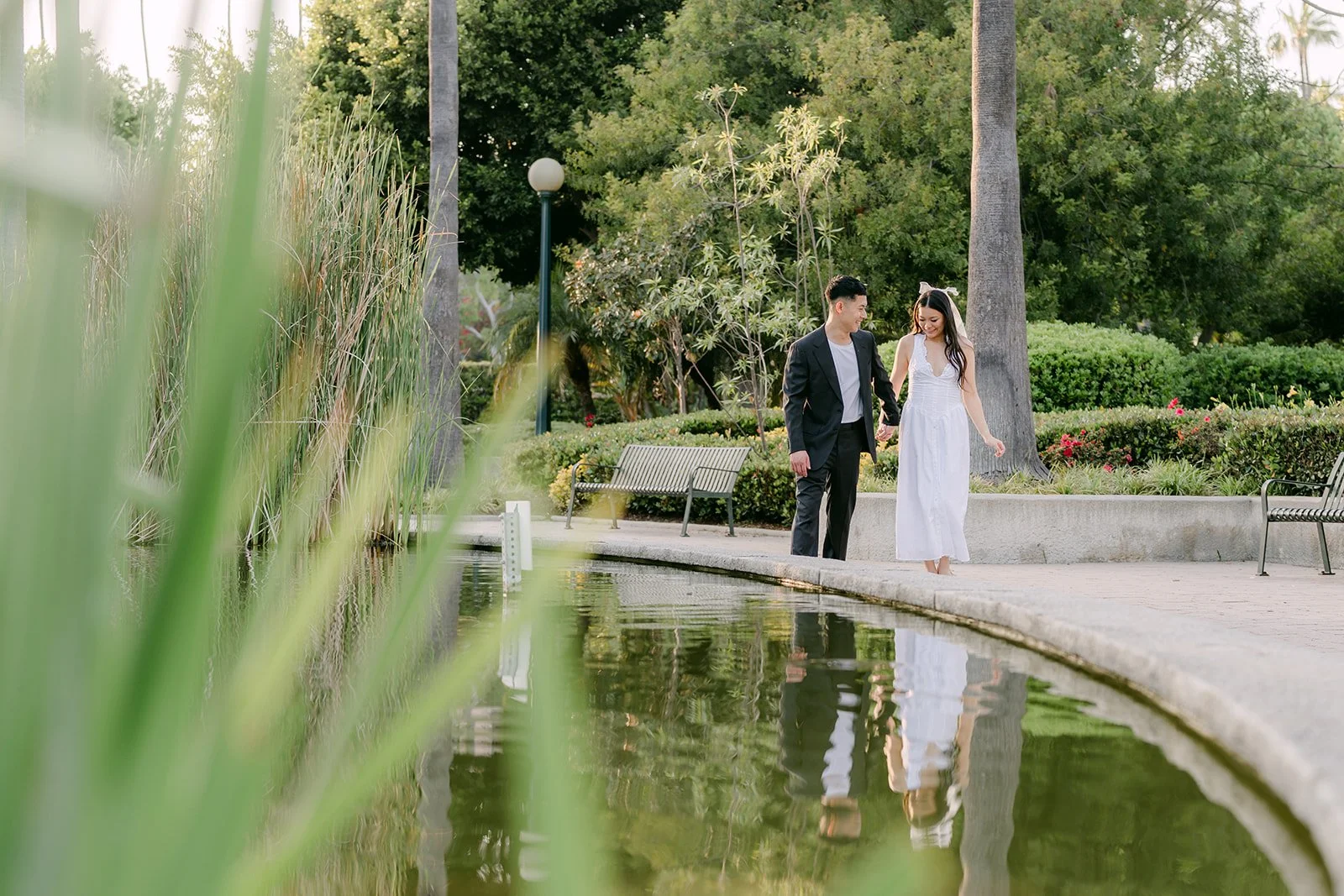 Jadee and Richard framed by the reeds and pond.
