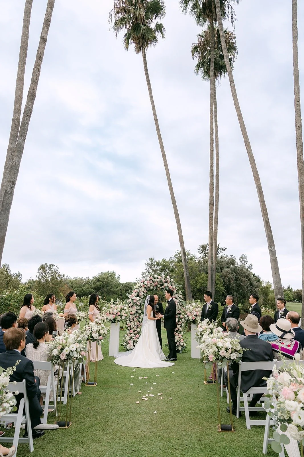 The full ceremony on the Los Coyotes lawn framed by tall palm trees