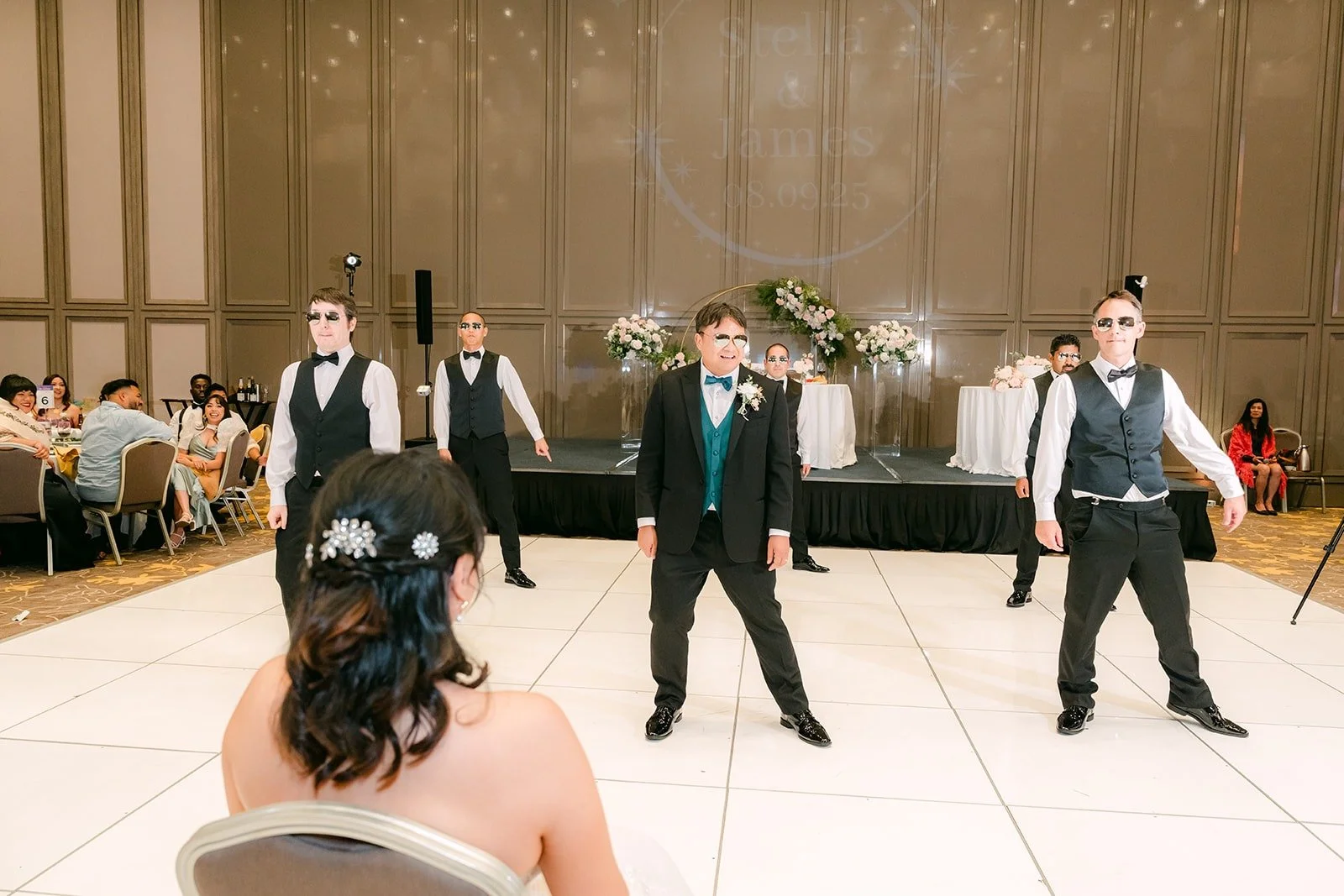 The groomsmen in sunglasses starting their surprise dance for Stella