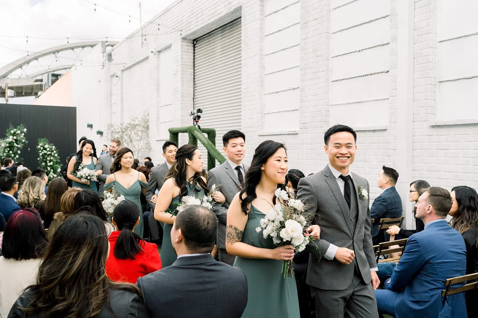 Guests watch the ceremony in the courtyard, photographed by One and Only Production