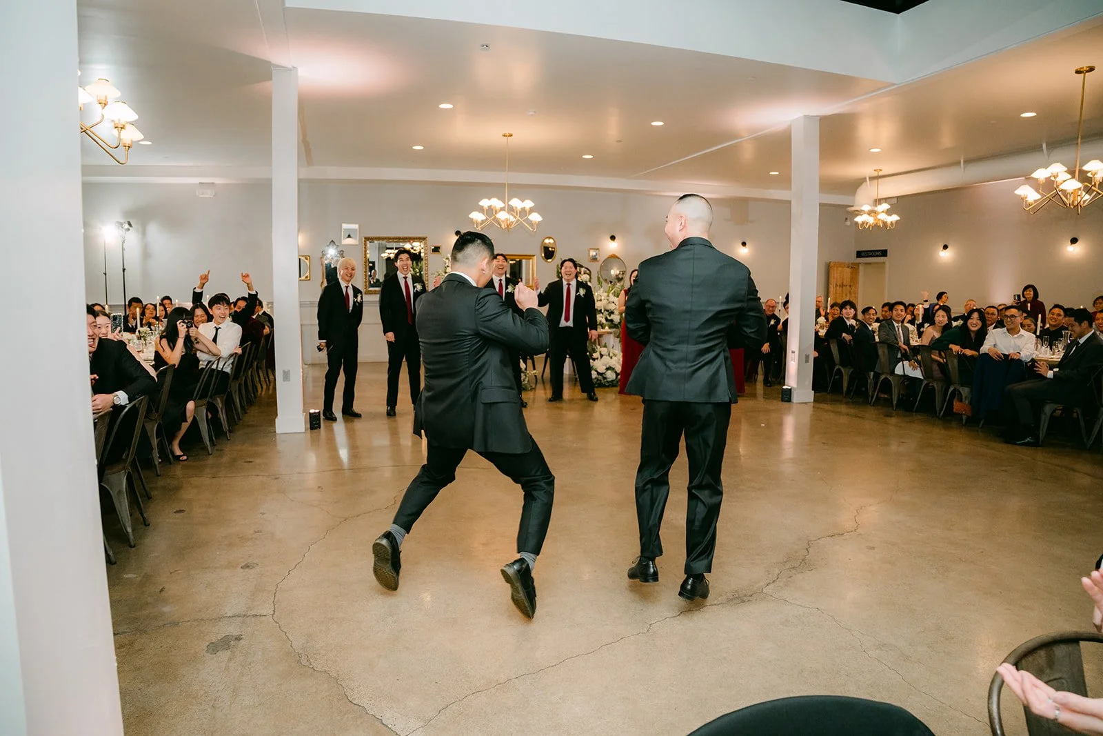 Groomsman dancing during the grand entrance