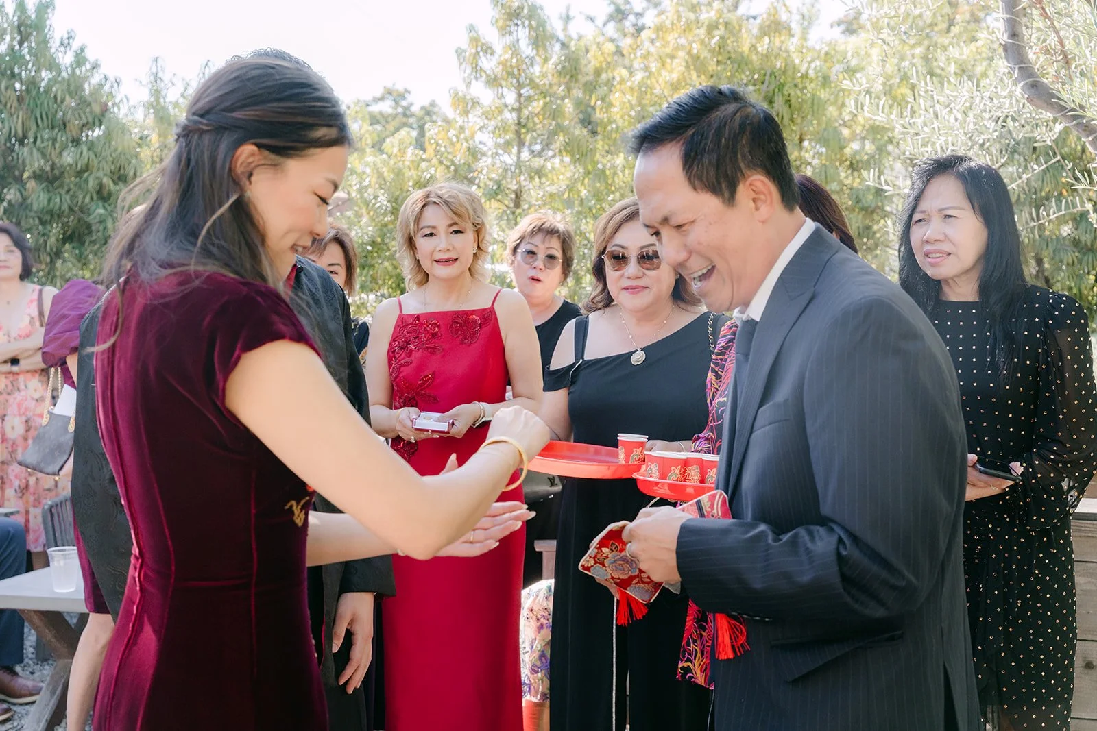 Jadee and Richard offering tea to relatives