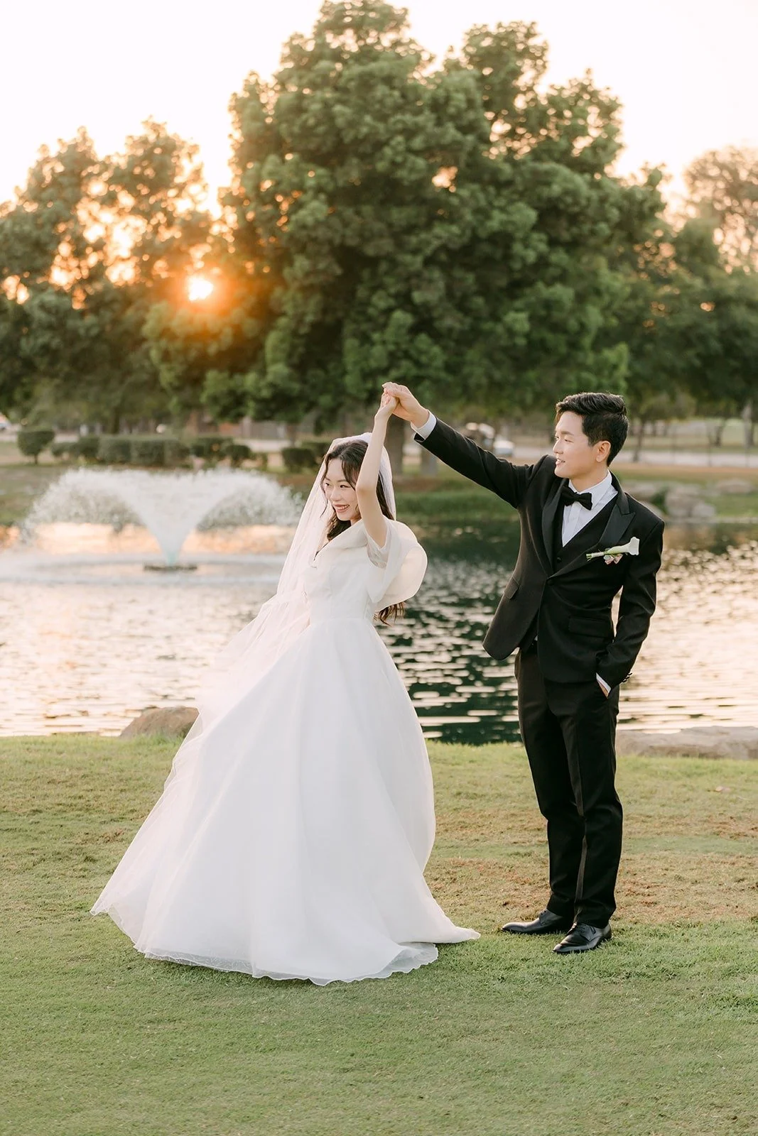 Eunsang twirling Jeannie beside the fountain
