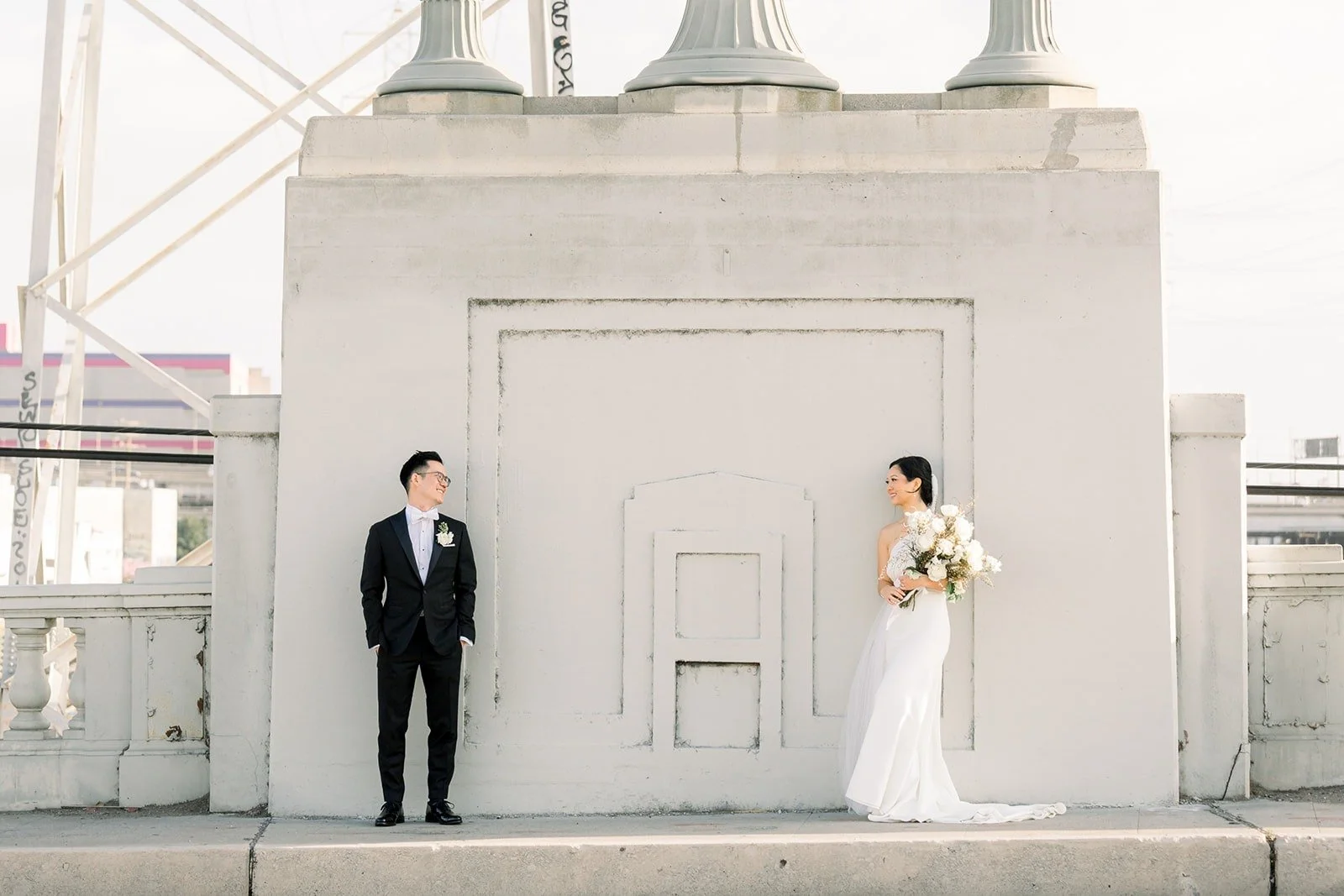 Cindy and Alex on the rooftop at The East Angel beside a white parapet