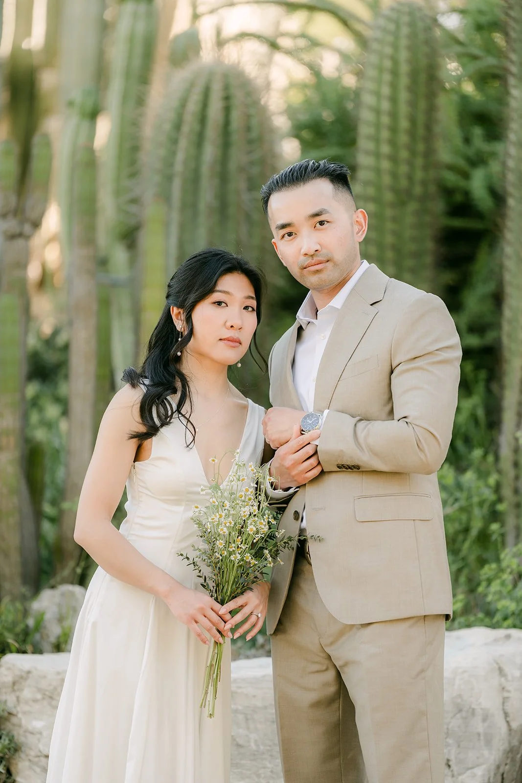 Kim and Vincent standing side by side among the columnar cacti.