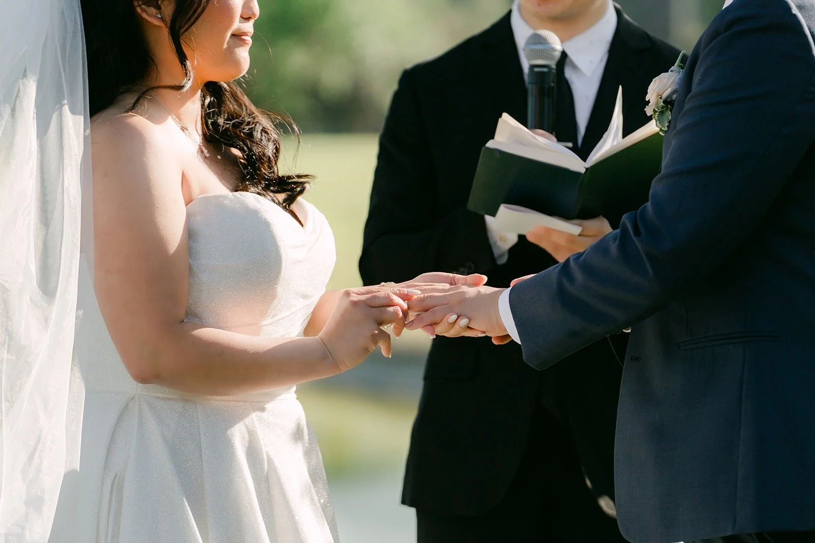 Close up of Jordan sliding the ring onto Florence's finger