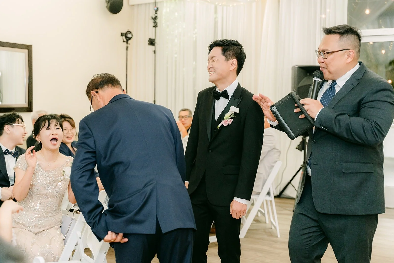The MC talking with guests during the reception