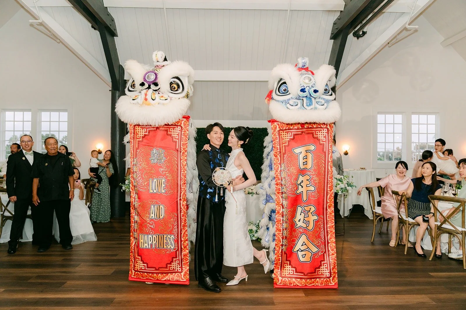 Tin and Fong with the lions and red couplet banners