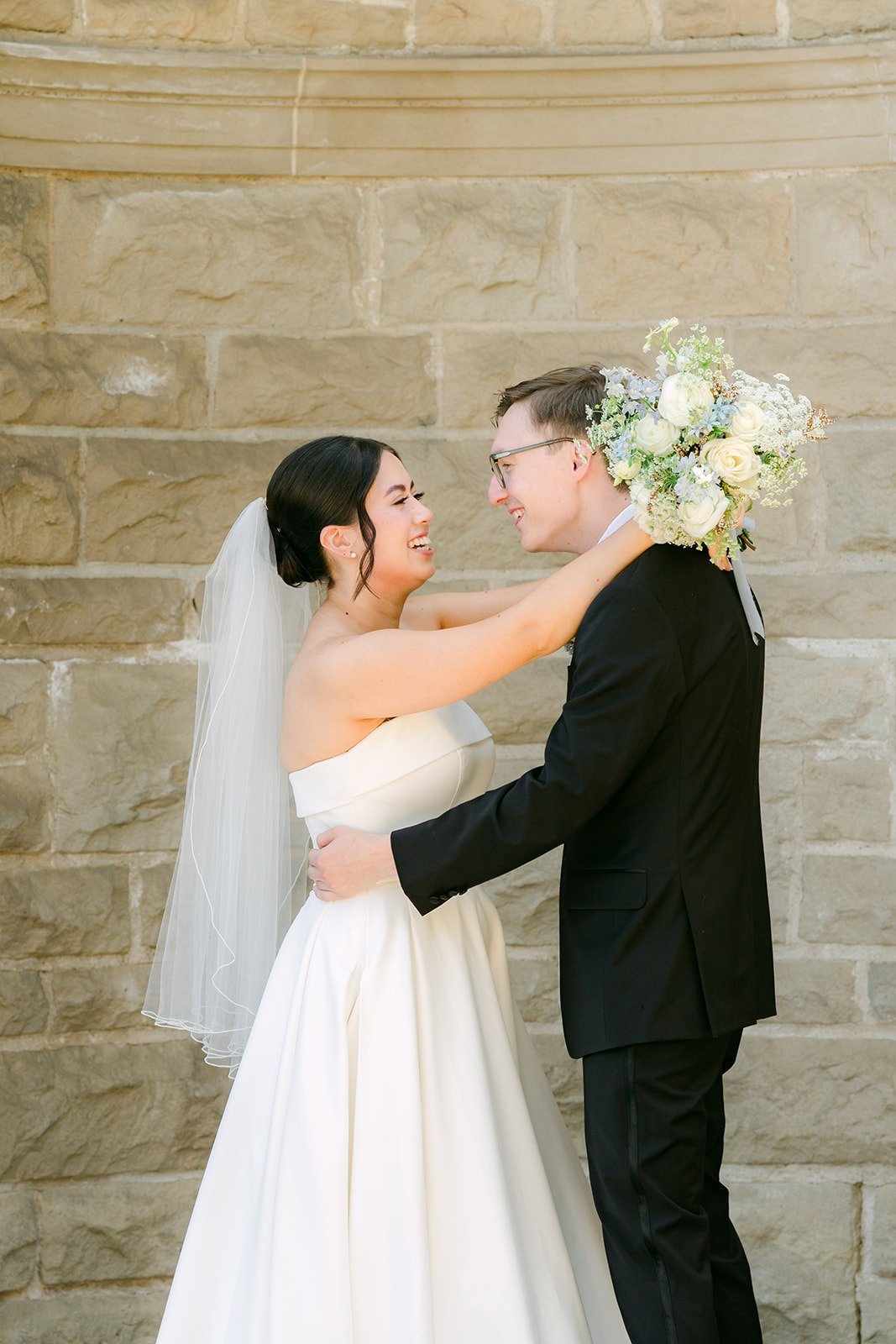 Brianna wrapping her arms around Nik, bouquet in hand